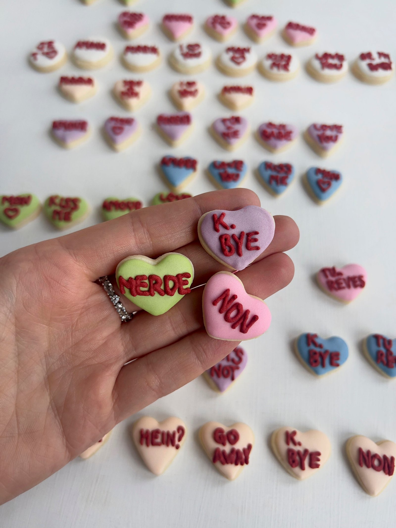 Close-up of sugar cookies with heart cut-outs and playful sassy wording.
