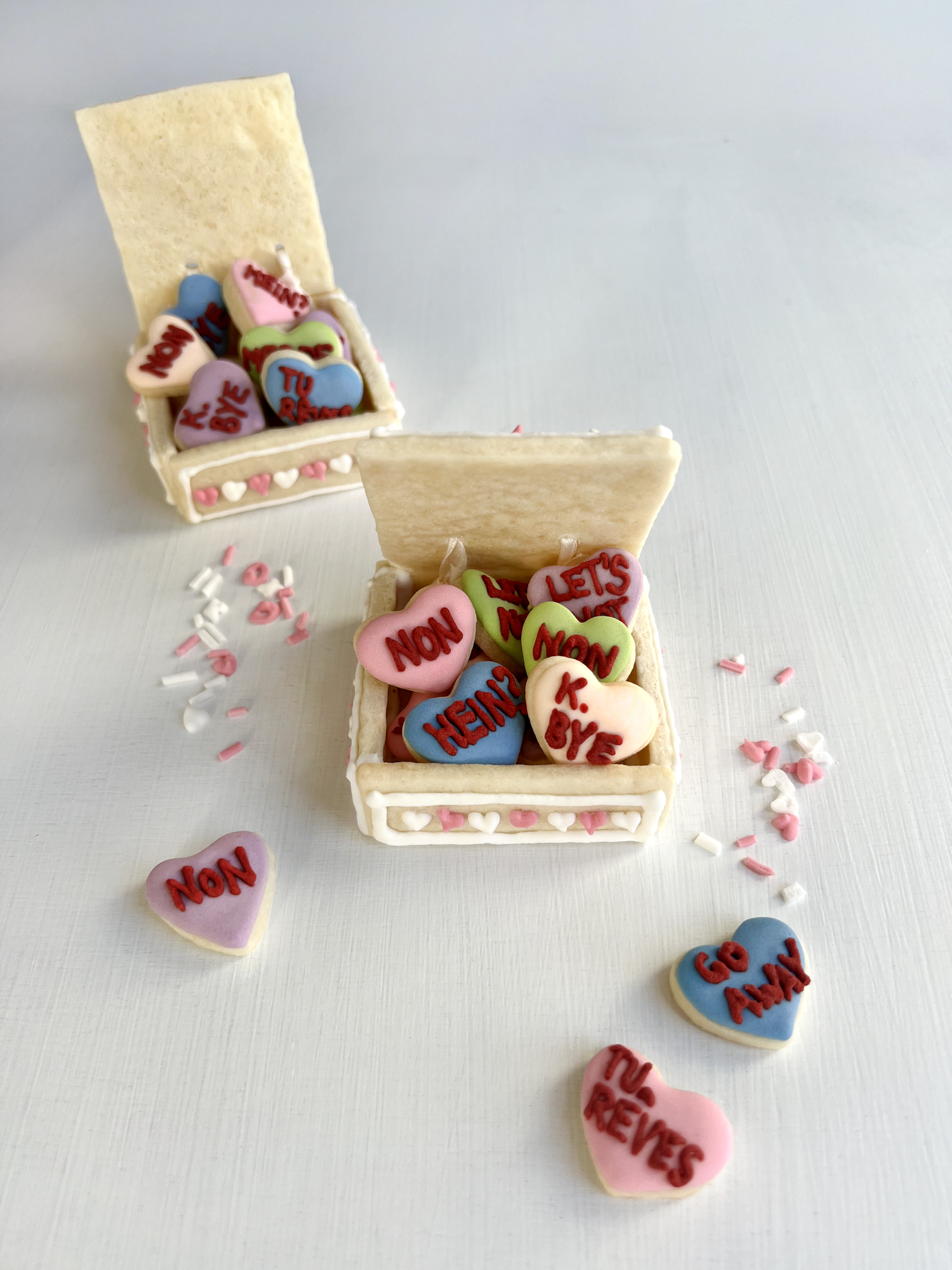 Close-up of sugar cookies with heart cut-outs and playful sassy wording.