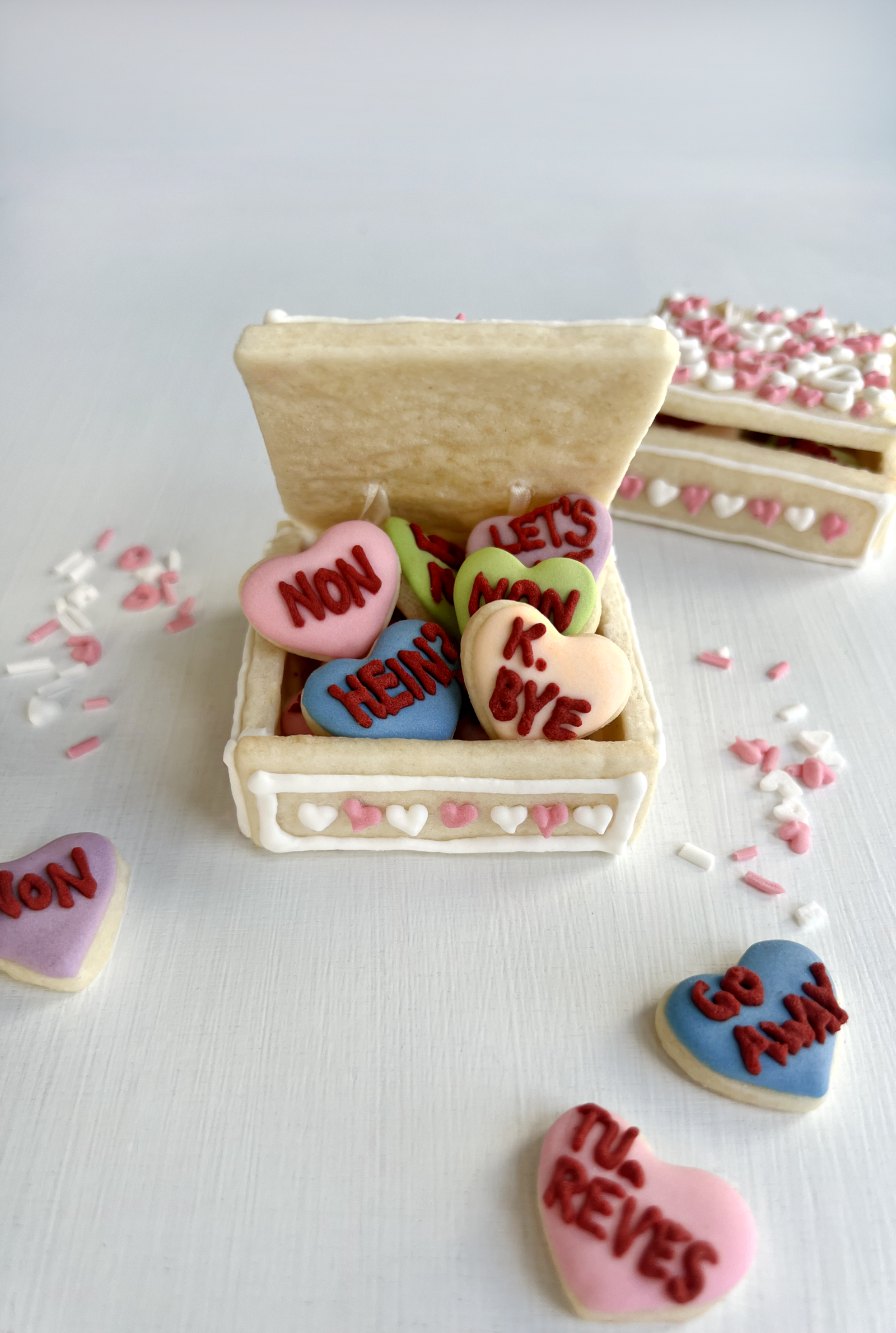 Sugar cookie box with small cut-out heart centres and sassy piped messages.